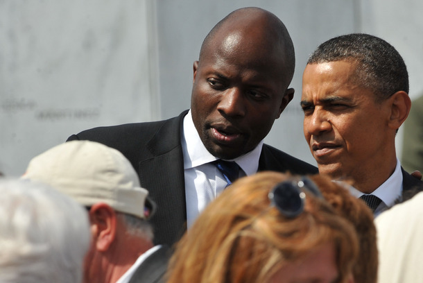 US President Barack Obama listens to his personal assistant Reggie Love as he greets family members of victims aboard United flight 93 on September 11, 2011 after he laid a wreath at the Wall of Names at the newly dedicated Flight 93 memorial on the site where the plane crashed in a field in Shanksville, Pennsylvania.    AFP PHOTO/Nicholas KAMM (Photo credit should read NICHOLAS KAMM/AFP/Getty Images)