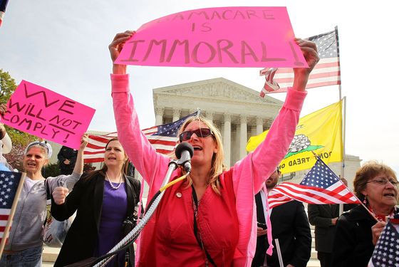 WASHINGTON, DC - MARCH 28:  Tea Party Patriots members, including national coordinator Jenny Beth Martin (2nd L), and Lisa Nancollas (C) of Lewistown, Pennsylvania, shout slogans during a rally in front of the U.S. Supreme Court March 28, 2012 in Washington, DC. This is the last of three-days of oral arguments in front of  the high court over the the Patient Protection and Affordable Care Act.  (Photo by Alex Wong/Getty Images)
