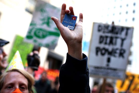 An Occupy Wall Street protestor holds up a cut up credit card d