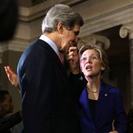 U.S. Sen. Elizabeth Warren (D-MA) (R) talks to Secretary of State and former U.S. Sen. John Kerry (D-MA) (L) during a re-enactment of the swearing-in for U.S. Senator William "Mo" Cowan (D-MA) February 7, 2013 at the Old Senate Chamber of the U.S. Capitol in Washington, DC. Cowan was appointed by Massachusetts Governor Deval Patrick as interim U.S. Senator to fill the seat that left vacant by Secretary of State and former U.S. Sen. John Kerry.