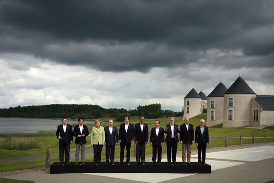 ENNISKILLEN, NORTHERN IRELAND - JUNE 18:  (L-R) President of the European Commission Jose Manuel Barroso, Japanese Prime Minister Shinzo Abe, German Chancellor Angela Merkel, Russia's President Vladimir Putin, Britain's Prime Minister David Cameron, US President Barack Obama, French President Francois Hollande, Canadian Prime Minister Stephen Harper, Italian Prime Minister Enrico Letta and European Council President Herman Van Rumpuy, arrive for the 'family' group photograph at the G8 venue of Lough Erne on June 18, 2013 in Enniskillen, Northern Ireland. The two day G8 summit, hosted by UK Prime Minister David Cameron, is being held in Northern Ireland for the first time. Leaders from the G8 nations have gathered to discuss numerous topics with the situation in Syria expected to dominate the talks.  (Photo by Matt Cardy/Getty Images)