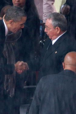  U.S. President Barack Obama (L) shakes hands with Cuban President Raul Castro during the official memorial service for former South African President Nelson Mandela at FNB Stadium December 10, 2013 in Johannesburg, South Africa.