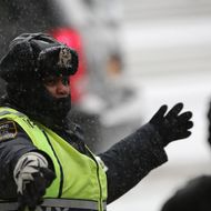 NEW YORK, NY - JANUARY 21:  A police officer directs traffic at Union Square during a snowstorm on January 21, 2014 in New York City. Areas of the Northeast are predicted to receive up to a foot of snow in what may be the biggest snowfall of the season so far.  (Photo by John Moore/Getty Images)
