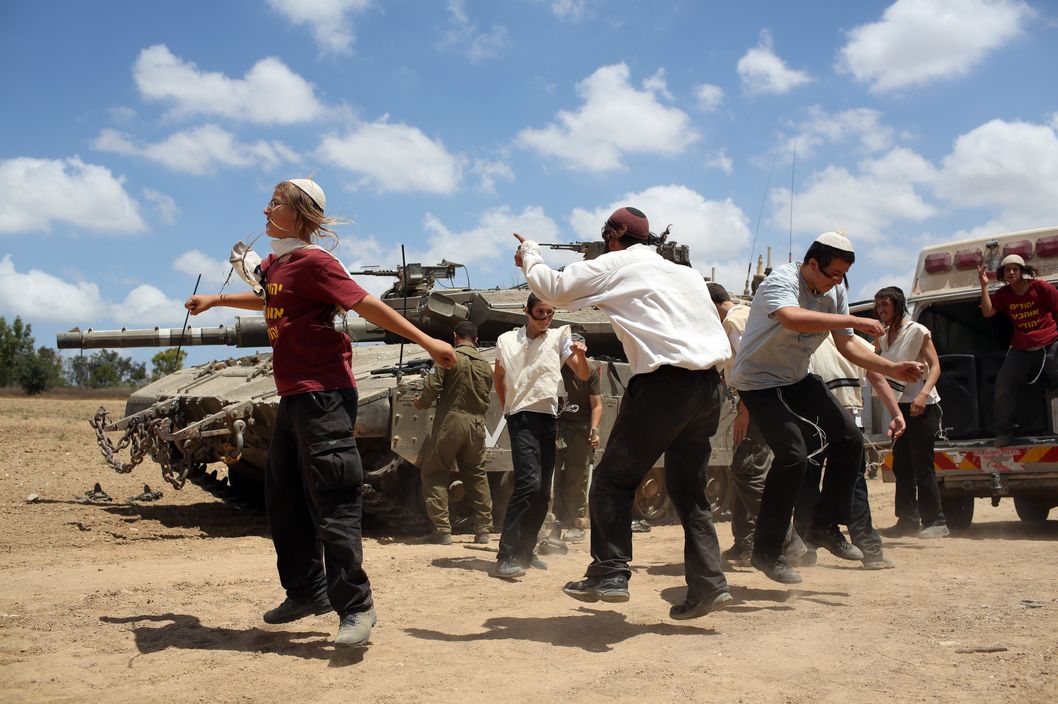 Young Orthodox Jews dance to support the soldiers at an army deployment area near Israel's border with the Gaza Strip, on July 17, 2014.