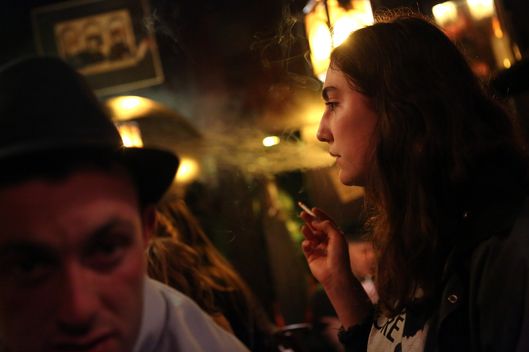 A woman smokes a cigarette at the Alt Berlin (Old Berlin) bar on April 22, 2014 in Berlin, Germany. 