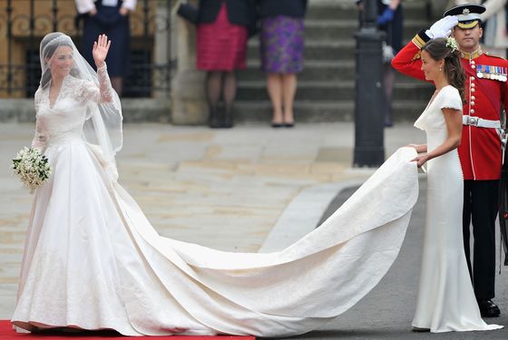 Kate in an Alexander McQueen dress by Sarah Burton, with her sister Pippa holding her train.