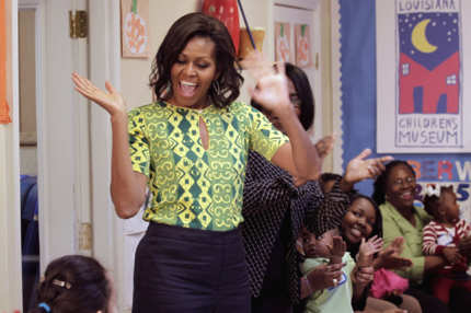 First lady Michelle Obama waves as she arrives to visit children, parents and staff at the Royal Castle Child Development Center, as part of her 'Lets Move!' initiative, Tuesday, Nov. 1, 2011, in New Orleans, La. (AP Photo/Gerald Herbert)