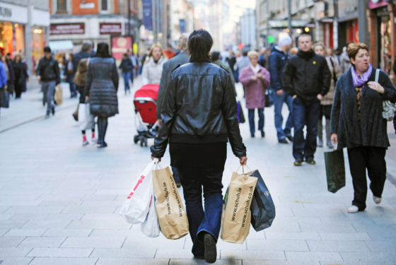 A shopper carries bags of purchases along Henry Street in Dublin, Ireland, on Tuesday, Dec. 27, 2011. Ireland, which spent this year trying to prove to investors its finances weren't like euro partners closer to the Mediterranean, may have to pay Greek and Portuguese rates next year to return to the credit market. Photographer: Aidan Crawley/Bloomberg via Getty Images