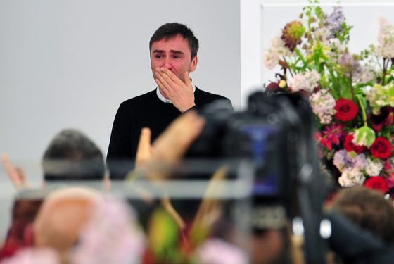 Belgian designer Raf Simons blows a kiss to the audience as he cries at the end of the Jil Sander Fall-winter 2012-2013 collection on February 25, 2012 during the Women's fashion week in Milan. The company announced the day before German fashion designer Jil Sander is set to make a return to the company that bears her name nearly eight years after resigning, with Simons leaving his position of creative director on February 27.  AFP PHOTO / GIUSEPPE CACACE (Photo credit should read GIUSEPPE CACACE/AFP/Getty Images)