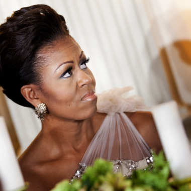 WASHINGTON - FEBRUARY 26: (AFP-OUT) First lady Michelle Obama listens to President Barack Obama speak in the State Dining Room of the White House February 26, 2012 in Washington, DC. President Obama and first lady Michelle Obama hosted 2012 Governors Dinner which coincides with the yearly meeting of the National Governors Association meeting in DC. (Photo by Brendan Smialowski/Getty Images)