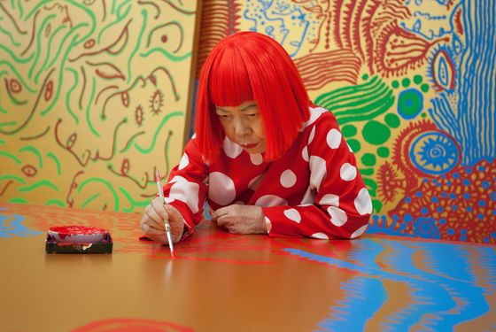 TOKYO, JAPAN - JANUARY 25:  Japanese artist Yayoi Kusama sits working on a new painting, in front of other newly finished paintings in her studio, on January 25, 2012 in Tokyo, Japan. Yayoi Kusama, who suffers from mental health problems and lives in a hospital near her studio, is one of today's most highly revered and popular of Japanese artists. She is one of the world's top selling living female artists breaking records in the millions. A major retrospective of her work is on display at Tate Modern in London through June 5, 2012.  (Photo by Jeremy Sutton-Hibbert/Getty Images)