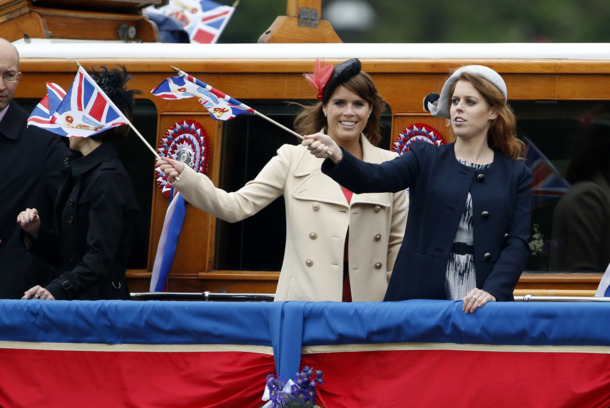 LONDON, ENGLAND - JUNE 03:  Princess Beatrice (R)  and Princess Eugenie wave from a barge in a flotilla of 1,000 vessels during the Diamond Jubilee Thames River Pageant on June 3, 2012 in London, England. For only the second time in its history the UK celebrates the Diamond Jubilee of a monarch. Her Majesty Queen Elizabeth II celebrates the 60th anniversary of her ascension to the throne. Thousands of well-wishers from around the world have flocked to London to witness the spectacle of the weekend’s celebrations. The Queen along with all members of the royal family will participate in a River Pageant with a flotilla of a 1,000 boats accompanying them down The Thames, the star studded free concert at Buckingham Palace, and a carriage procession and a service of thanksgiving at St Paul’s Cathedral.  (Photo by Matt Dunham - WPA Pool/Getty Images)