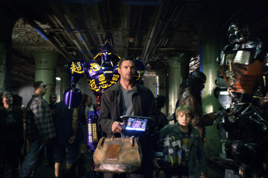 "REAL STEEL"
RS-FF-006
Down-on-his-luck fight promoter Charlie Kenton (Hugh Jackman, left) and his son, Max (Dakota Goyo, right) enter their star robot boxer Noisy Boy in a match at the Crash Palace in DreamWorks Pictures' action drama "Real Steel".
?DreamWorks II Distribution Co., LLC. ?All Rights Reserved.