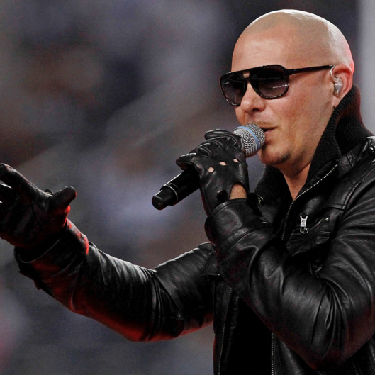 ARLINGTON, TX - NOVEMBER 24: Singer Pitbull performs at halftime during the Thanksgiving Day game between the Miami Dolphins and the Dallas Cowboys at Cowboys Stadium on November 24, 2011 in Arlington, Texas. (Photo by Ronald Martinez/Getty Images)