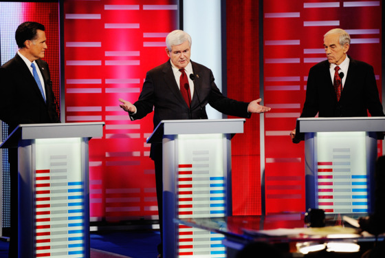 DES MOINES, IA - DECEMBER 10: Former speaker of the House Newt Gingrich (C) speaks while former Massachusetts Gov. Mitt Romney (L) and U.S. Rep. Ron Paul (R-TX) look on during th ABC News GOP Presidential debate on the campus of Drake University on December 10, 2011 in Des Moines, Iowa. Rivals were expected to target front runner Gingrich in the debate hosted by ABC News, Yahoo News, WOI-TV, The Des Moines Register and the Iowa GOP. (Photo by Kevork Djansezian/Getty Images) DES MOINES, IA - DECEMBER 10: Former speaker of the House Newt Gingrich (C) speaks while former Massachusetts Gov. Mitt Romney (L) and U.S. Rep. Ron Paul (R-TX) look on during th ABC News GOP Presidential debate on the campus of Drake University on December 10, 2011 in Des Moines, Iowa. Rivals were expected to target front runner Gingrich in the debate hosted by ABC News, Yahoo News, WOI-TV, The Des Moines Register and the Iowa GOP. (Photo by Kevork Djansezian/Getty Images)