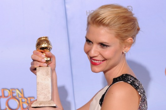The winner for Best Performance by and Actress In a Television Series Drama Claire Danes poses with the trophy at the 69th annual Golden Globe Awards at the Beverly Hilton Hotel in Beverly Hills, California, January 15, 2012. AFP PHOTO / Robyn BECK (Photo credit should read ROBYN BECK/AFP/Getty Images)