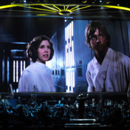 LAS VEGAS - MAY 29: Actress Carrie Fisher's Princess Leia Organa character and actor Mark Hamill's Luke Skywalker character from "Star Wars Episode IV: A New Hope" are shown on screen while musicians perform during "Star Wars: In Concert" at the Orleans Arena May 29, 2010 in Las Vegas, Nevada. The traveling production features a full symphony orchestra and choir playing music from all six of John Williams' Star Wars scores synchronized with footage from the films displayed on a three-story-tall, HD LED screen. (Photo by Ethan Miller/Getty Images) LAS VEGAS - MAY 29: Actress Carrie Fisher's Princess Leia Organa character and actor Mark Hamill's Luke Skywalker character from "Star Wars Episode IV: A New Hope" are shown on screen while musicians perform during "Star Wars: In Concert" at the Orleans Arena May 29, 2010 in Las Vegas, Nevada. The traveling production features a full symphony orchestra and choir playing music from all six of John Williams' Star Wars scores synchronized with footage from the films displayed on a three-story-tall, HD LED screen. (Photo by Ethan Miller/Getty Images)