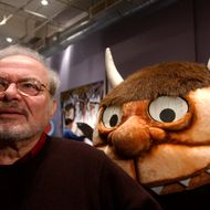 399514 02: Standing with a character from his book "Where the Wild Things Are," author and illustrator Maurice Sendak speaks with the media January 11, 2002 before the opening of an exhibition entitled, "Maurice Sendak In His Own Words and Pictures," at the Childrens Museum of Manhattan in New York City. The multimedia exhibition, which opens January 12, will feature photographs, text, illustrations, music and audiovisual components. (Photo by Spencer Platt/Getty Images)