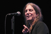 US rock singer and poet Patti Smith gestures as she performs on stage in the eastern French city of Charleville-Mezieres on November 11, 2011, where she pays tribute to French poet Arthur Rimbaud for the 120th anniversary of Rimbaud's death. PHOTO AFP / FRANCOIS NASCIMBENI (Photo credit should read FRANCOIS NASCIMBENI/AFP/Getty Images)