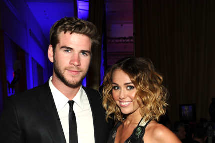 Actress/singer Miley Cyrus and Liam Hemsworth backstage during Muhammad Ali's Celebrity Fight Night XVIII held at JW Marriott Desert Ridge Resort & Spa on March 24, 2012 in Phoenix, Arizona.