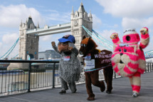LONDON, ENGLAND - APRIL 20: Competitors attempting to break various Guinness World Records pose in front of Tower Bridge during a photocall ahead of the Virgin London Marathon 2012 on April 20, 2012 in London, England. Mark Millrine will attempt to break the Guinness World Record for the fastest marathon completed dressed as a book character. Marc Jenner, dressed in costume as children's tv programme character Bagpuss will attempt to break the Guinness World Record for the fastest marathon completed dressed as a television character. (Photo by Andrew Redington/Getty Images)