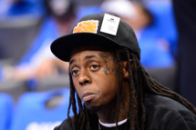 OKLAHOMA CITY, OK - JUNE 12: Rapper Lil Wayne sits courtside during halftime as the Oklahoma City Thunder take on the Miami Heat in Game One of the 2012 NBA Finals at Chesapeake Energy Arena on June 12, 2012 in Oklahoma City, Oklahoma. NOTE TO USER: User expressly acknowledges and agrees that, by downloading and or using this photograph, User is consenting to the terms and conditions of the Getty Images License Agreement. (Photo by Ronald Martinez/Getty Images)