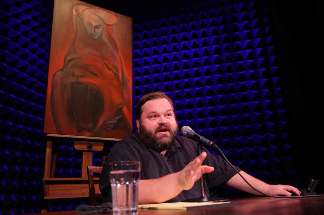 Mike Daisey in All the Faces of the Moon with the oil painting from Chapter 13, That Hideous Strength by artist Larissa Tokmakova, directed by Jean-Michele Gregory, running in Joe's Pub at The Public Theater through October 3.