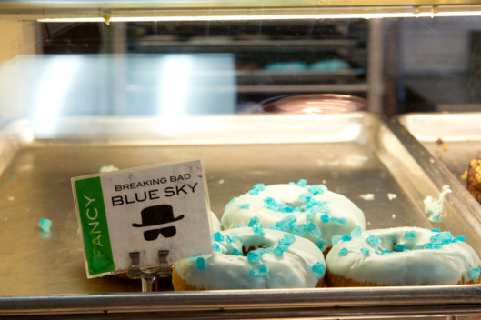 ALBUQUERQUE, NM - AUGUST 31: Several years ago a production assistant for AMC’s "Breaking Bad" stopped into Rebel Donuts at 2435 Wyoming NE, Albuquerque, New Mexico and asked them to make up several boxes of donuts topped with icing and blue rock candy to resemble Heisenberg’s blue meth. The donuts were taken to the shooting location and were an instant hit. They are now a regular item in their shop. A photograph of Aaron Paul holding a box of "Breaking Bad" Blue Sky donuts now hangs on the wall of the shop. (Photo by Steve Snowden / Getty Images)
