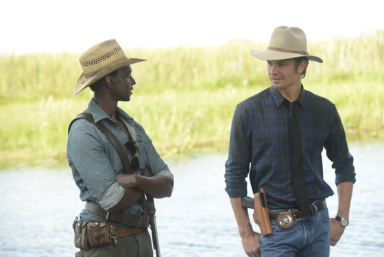 JUSTIFIED -- A Murder of Crowes -- Episode 501 (Airs Tuesday, January 7, 10:00 pm e/p) -- Pictured: (L-R) Edi Gathegi as Jean Baptiste, Timothy Olyphant as Deputy U.S. Marshal Raylan Givens -- CR: Guy D'Alama/FX JUSTIFIED -- A Murder of Crowes -- Episode 501 (Airs Tuesday, January 7, 10:00 pm e/p) -- Pictured: (L-R) Edi Gathegi as Jean Baptiste, Timothy Olyphant as Deputy U.S. Marshal Raylan Givens -- CR: Guy D'Alama/FX