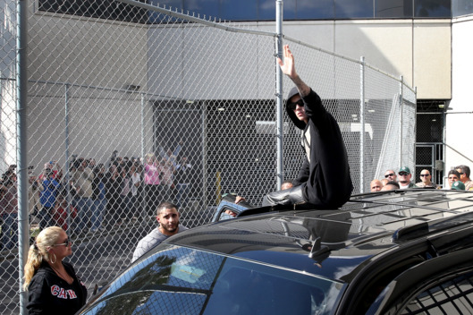 MIAMI, FL - JANUARY 23: Justin Bieber waves after exiting from the Turner Guilford Knight Correctional Center on January 23, 2014 in Miami, Florida. Justin Bieber was charged with drunken driving, resisting arrest and driving without a valid license after Miami Beach police found the pop star street racing Thursday morning. (Photo by Joe Raedle/Getty Images)