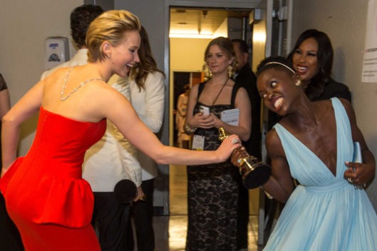 Actresses Jennifer Lawrence (L) and Lupita Nyong'o backstage during the Oscars held at Dolby Theatre on March 2, 2014 in Hollywood, California.