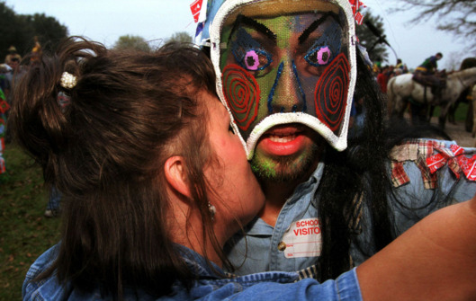 F365699 10: Costumed men dance to Cajun music during Mardi Gras celebrations in Mamou, Louisiana March 7, 2000. The traditional party is meant as a the celebration before Ash Wednesday. The participants visit homes in the area of Mamou to chase chickens and other birds that are thrown to the group. (Photo by Joe Raedle)