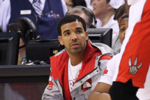 TORONTO, ON - APRIL 19: Rap star Drake takes in the action between the Brooklyn Nets and the Toronto Raptors in Game One of the NBA Eastern Conference play-off at the Air Canada Centre on April 19, 2014 in Toronto, Ontario, Canada. The Nets defeated the Raptors 94-87 to take a 1-0 series lead. NOTE TO USER: user expressly acknowledges and agrees that, by downloading and/or using this Photograph, user is consenting to the terms and conditions of the Getty Images License Agreement. (Photo by Claus Andersen/Getty Images) *** Local Caption *** Drake