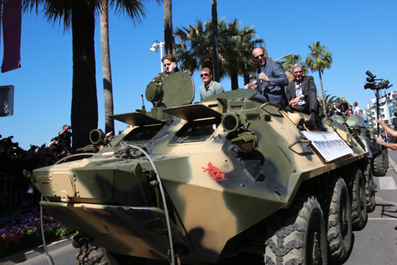 Swedish actor Dolph Lundgren (2ndL), British actor Jason Statham (2ndR) and US actor Harrison Ford (R) arrive on a tank for a photocall for the film "The Expendables 3" at the 67th edition of the Cannes Film Festival in Cannes, southern France, on May 18, 2014. Swedish actor Dolph Lundgren (2ndL), British actor Jason Statham (2ndR) and US actor Harrison Ford (R) arrive on a tank for a photocall for the film "The Expendables 3" at the 67th edition of the Cannes Film Festival in Cannes, southern France, on May 18, 2014.