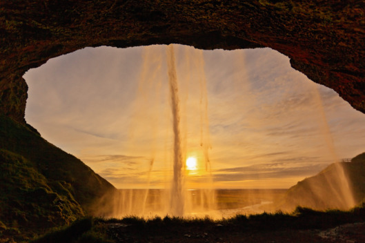 Skogafoss waterfall situated in the south of Iceland at the cliffs of the former coastline. After the coastline had receded seaward the former sea cliffs remained, parallel to the coast over hundreds of kilometers, creating together with some mountains a clear border between the coastal lowlands and the Highlands of Iceland. The Skogafoss is one of the biggest waterfalls of the country with a width of 25 meters and a drop of 60 meters. At least 20 more waterfalls cascade down the mountain slopes above the Skogafoss