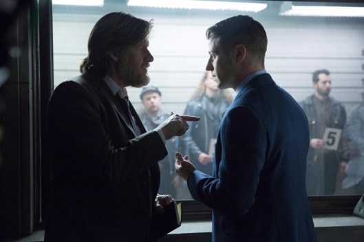 Gordon (Ben McKenzie, R) and Bullock (Donal Logue, L) participate in a police line-up in the "Red Hood" episode of GOTHAM.