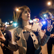 A member of Occupy LA protests on the street in front of City Hall in downtown on November 28, 2011.