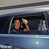 Republican presidential candidate and former Massachusetts Gov. Mitt Romney gives a thumbs up after speaking to supporters in front of vacant stores of the Valley Plaza shopping center to a campaign stop on July 20, 2011 in Los Angeles, California.
