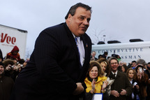 New Jersey Governor Chris Christie looks on during a campaign rally outside a grocery store in Des Moines, Iowa, on December 30, 2011. Romney on Friday ripped President Barack Obama over his annual Hawaii vacation, painting him as out of touch with Americans' economic suffering.