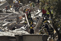 Rescuers work amid the wreckage caused by an explosion in a hospital in Cuajimalpa, Mexico City, on January 29, 2015.