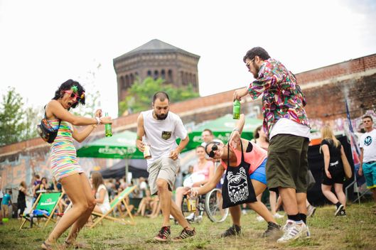 BERLIN, GERMANY - AUGUST 03:  A group of visitors dance on the lawn during the Hipster Cup on August 3, 2013 in Berlin, Germany.  This is the third year for what has now become an annual event. (Photo by Christian Marquardt/Getty Images)