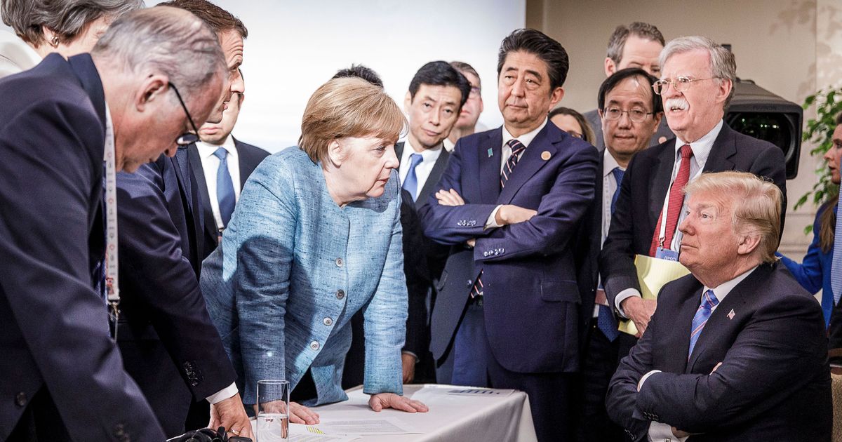CHARLEVOIX, CANADA - JUNE 9:   In this photo provided by the German Government Press Office (BPA), German Chancellor Angela Merkel deliberates with US president Donald Trump on the sidelines of the official agenda on the second day of the G7 summit on June 9, 2018 in Charlevoix, Canada. Also pictured are (L-R) Larry Kudlow, director of the US National Economic Council, Theresa May, UK prime minister, Emmanuel Macron, French president, Angela Merkel, Yasutoshi Nishimura, Japanese deputy chief cabinet secretary, Shinzo Abe, Japan prime minister, Kazuyuki Yamazaki, Japanese senior deputy minister for foreign affairs, John Bolton, US national security adviser, and Donald Trump. Canada are hosting the leaders of the UK, Italy, the US, France, Germany and Japan for the two day summit.