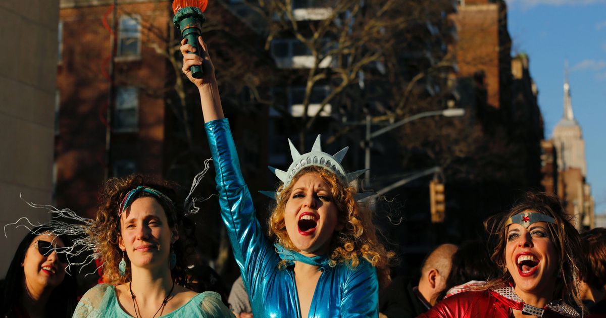 A woman dressed as Statue of Liberty reacts as she takes part during an  International Women's Strike Rally in Washington square park on March 8, 2017 in New York City. 