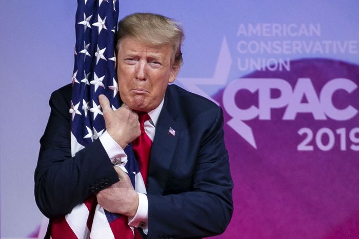 https://pixel.nymag.com/imgs/daily/intelligencer/2019/03/02/02-CPAC-Trump-Hugs-Flag.w700.h467.jpg