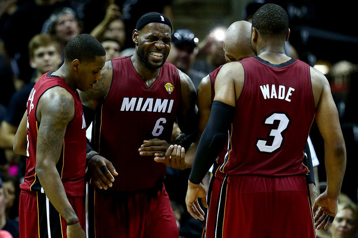 LeBron James #6 of the Miami Heat reacts after cramping up against the San Antonio Spurs during Game One of the 2014 NBA Finals at the AT&T Center on June 5, 2014 in San Antonio, Texas.