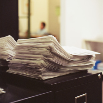 Stacks of papers on desk