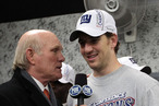 Eli Manning #10 of the New York Giants is interviewed in the locker room by Terry Bradshaw