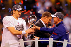 Eli Manning #10 of the New York Giants poses with the Vince Lombardi Trophy and his head coach Tom Coughlin after the Giants defeated the Patriots by a score of 21-17 in Super Bowl XLVI at Lucas Oil Stadium on February 5, 2012 in Indianapolis, Indiana.