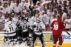 Dustin Penner #25 of the Los Angeles Kings celebrates with teammates Slava Voynov #26, Jeff Carter #77 and Mike Richards #10 after Penner scores the game-winning goal in overtime as the Kings defeat the Phoenix Coyotes 4-3 in Game Five of the Western Conference Final during the 2012 NHL Stanley Cup Playoffs at Jobing.com Arena on May 22, 2012 in Phoenix, Arizona.