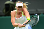 Russia's Maria Sharapova plays a shot during her first round women's singles match against Australia's Anastasia Rodionova on the first day of the 2012 Wimbledon Championships tennis tournament at the All England Tennis Club in Wimbledon, southwest London, on June 25, 2012.